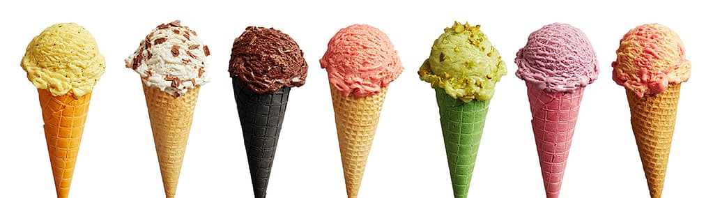 Scoops of various ice cream flavors in different colored ice cream cones