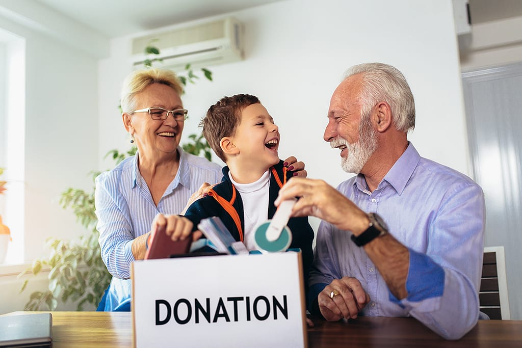 stock of photo family donating unwanted items they are holding box with stuffs for donation