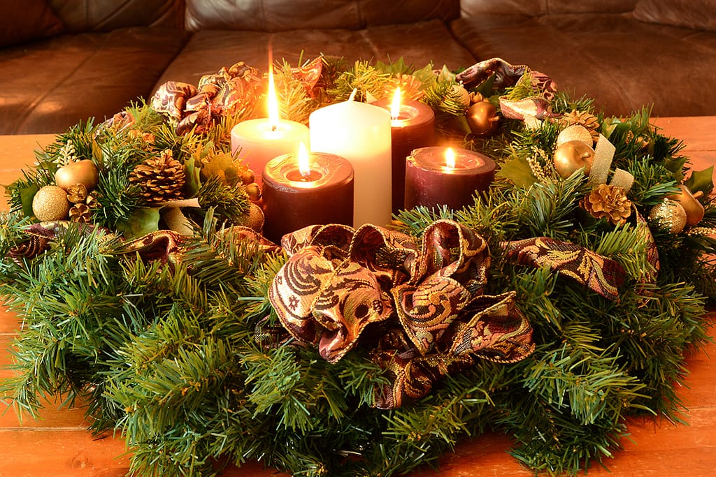 Traditional Advent Wreath On Rustic Table With Candles Glowing Warm
