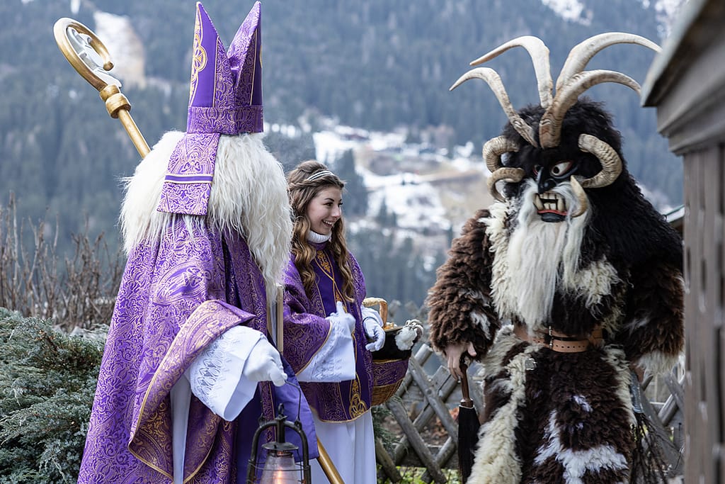 Saint Nicholas Angel And Krampus Prepare For The Traditional Christmas Procession In The Highlands Of Austria Salzburg