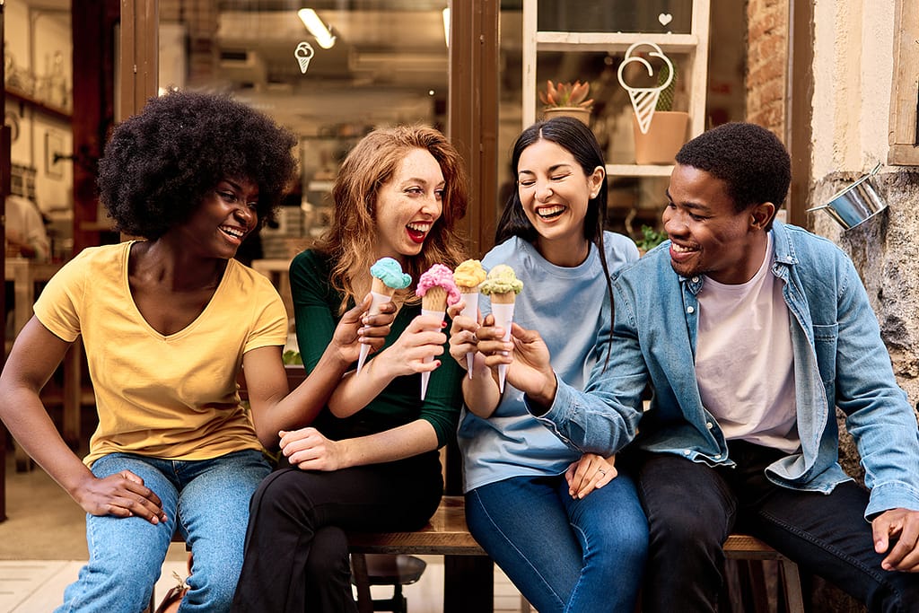 Multiethnic Group Of Friends Toasting With Colorful Ice Creams Outdoors