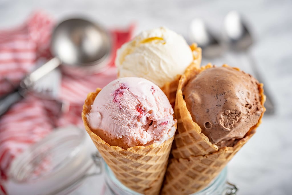 Strawberry Vanilla Chocolate Ice Cream With Waffle Cone On Marble Stone Backgrounds