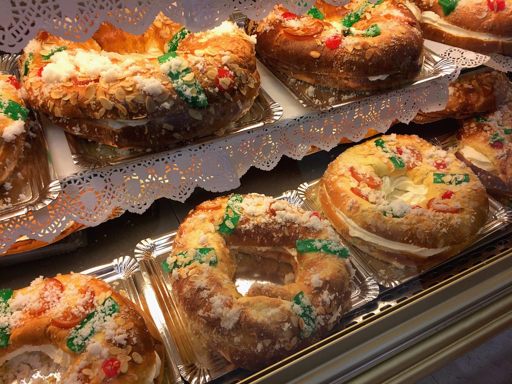 A row of Roscon de reyes, a traditional cake served on Christmas in Spain, are lined up in a pastry shop in Spain