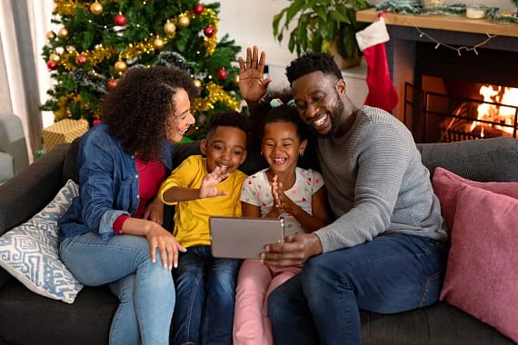 A family watching a keepsake video of their virtual Santa visit