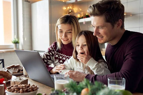 A family enjoying a virtual Santa visit from the comfort of their own home