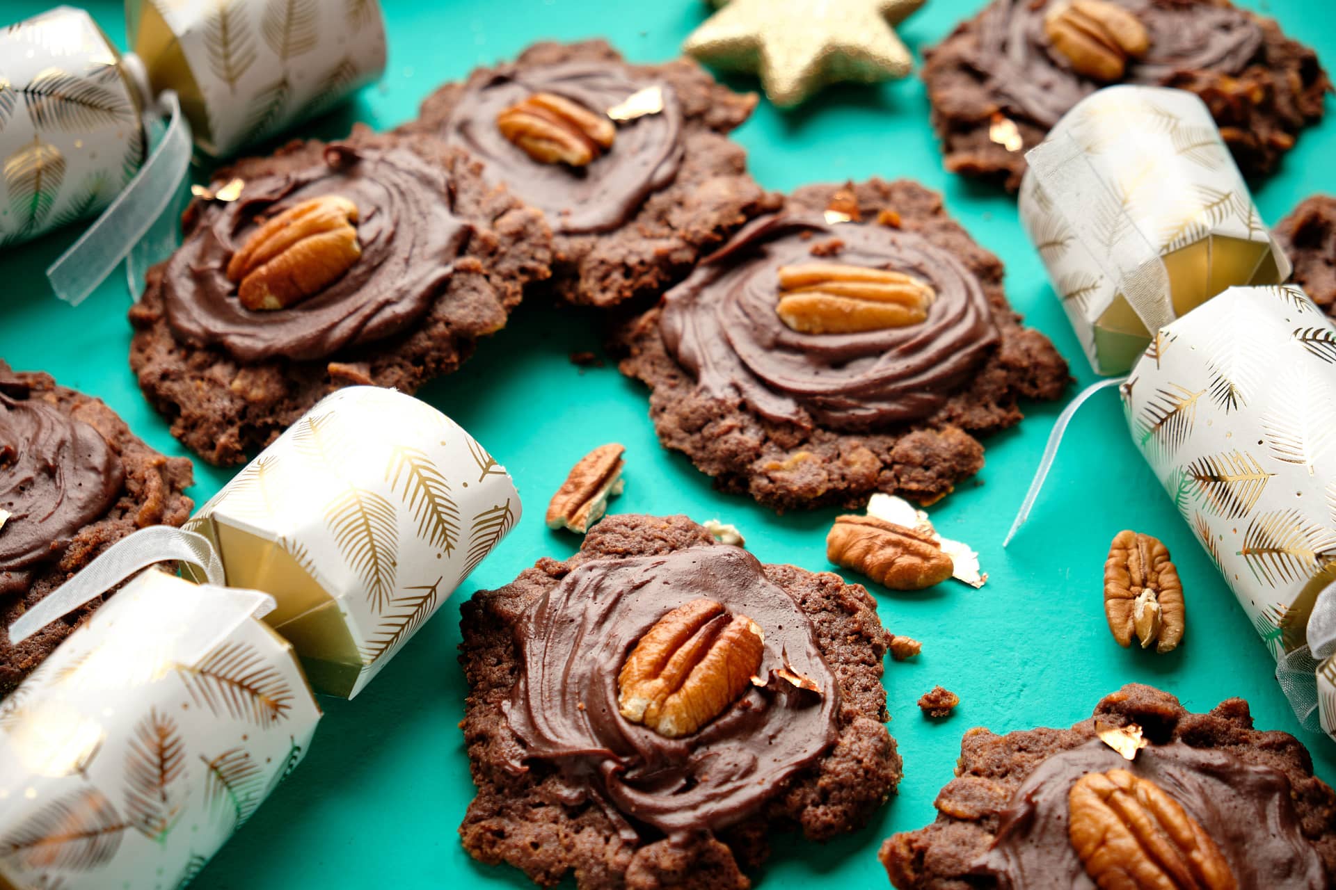 A Plate of New Zealand Chocolate Roughs surrounded by Christmas Crackers and walnut halves
